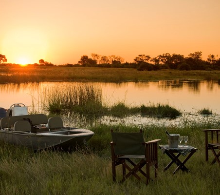 Boat And Drinks At Sunset on safari in Africa ®bushtreksafaris