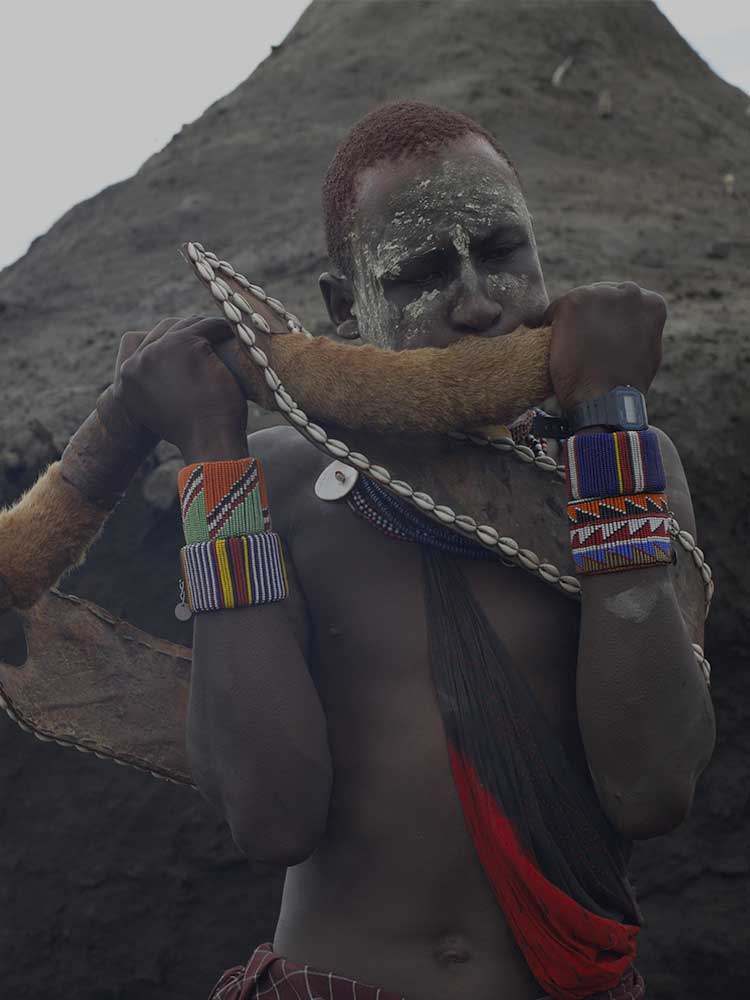 Maasai Blowing Horn during rare private ceremony meet the maasai on safari in Kenya with ©bushtreksafaris