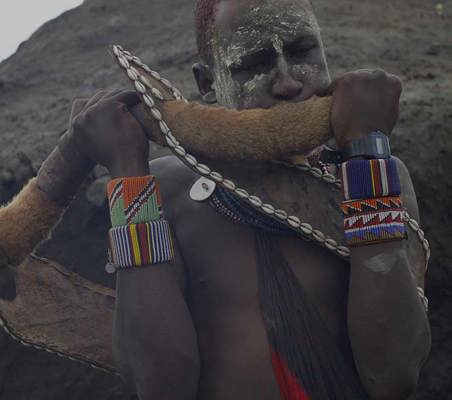 Maasai Blowing Horn during rare private ceremony meet the maasai on safari in Kenya with ©bushtreksafaris