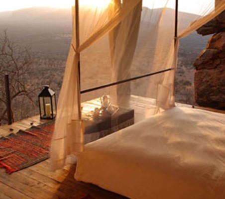 view from luxury lodge bed deck overlooking samburu plains safari